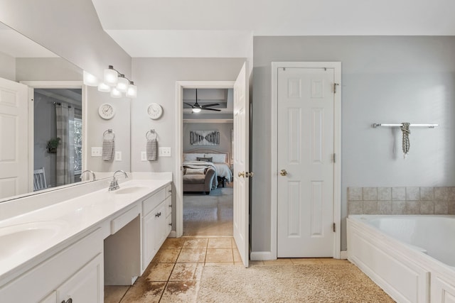 bathroom with a bathtub, vanity, ceiling fan, and tile patterned floors