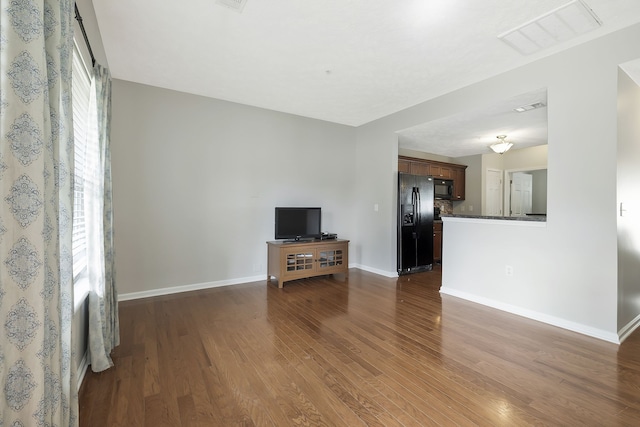 unfurnished living room featuring dark hardwood / wood-style flooring