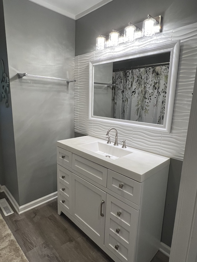 bathroom with hardwood / wood-style flooring and vanity