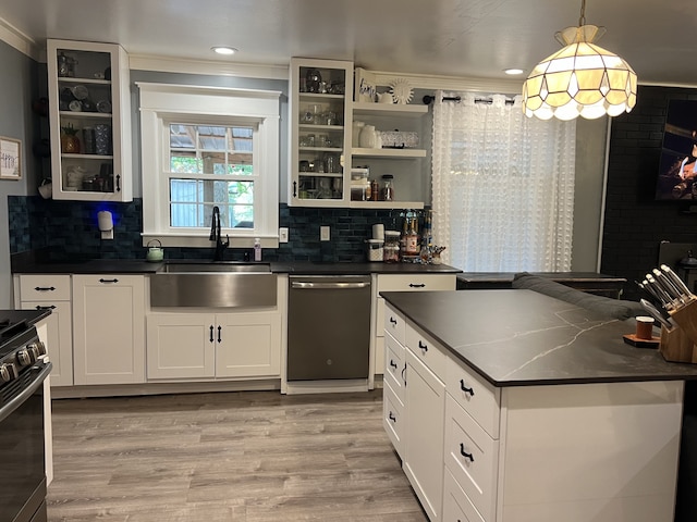 kitchen with white cabinets, sink, decorative light fixtures, dishwasher, and light hardwood / wood-style floors