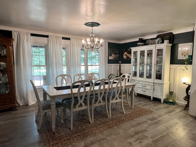 dining room featuring a notable chandelier, dark hardwood / wood-style flooring, and ornamental molding