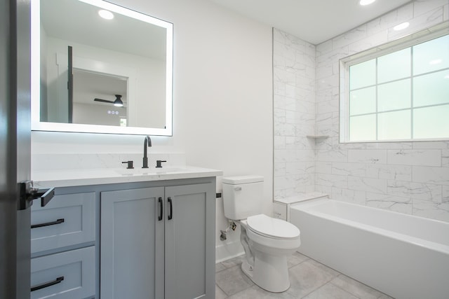 full bathroom featuring tile patterned flooring, vanity, ceiling fan, tiled shower / bath, and toilet