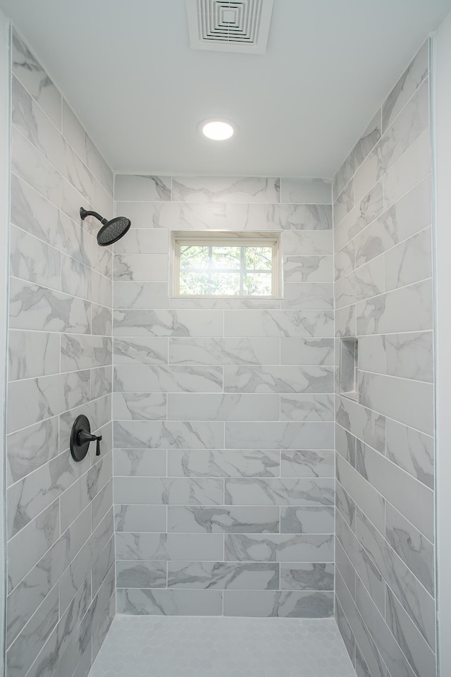 bathroom with a tile shower