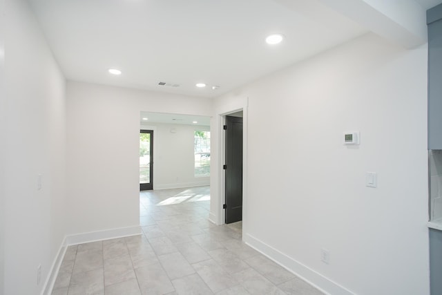 corridor with light tile patterned flooring