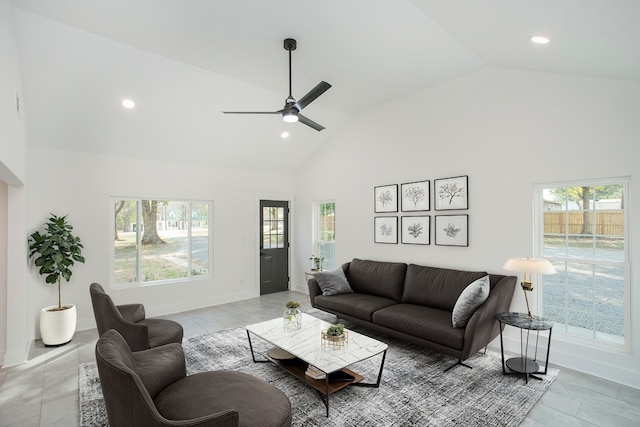 living room with ceiling fan, high vaulted ceiling, and a healthy amount of sunlight