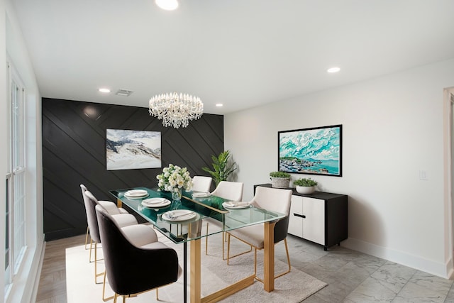 dining space with an inviting chandelier and light hardwood / wood-style flooring