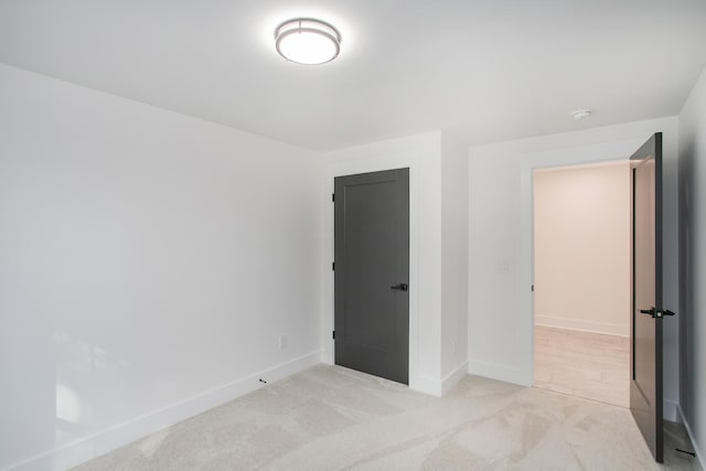 unfurnished bedroom featuring light carpet