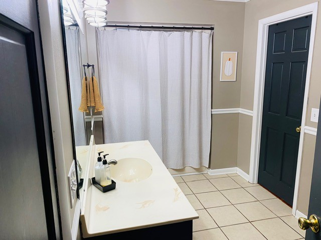 bathroom featuring tile patterned flooring, vanity, and a shower with curtain