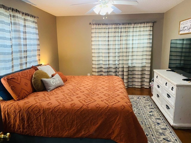 bedroom featuring dark hardwood / wood-style floors and ceiling fan