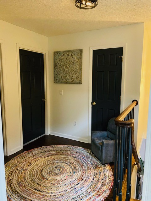 foyer entrance with a textured ceiling