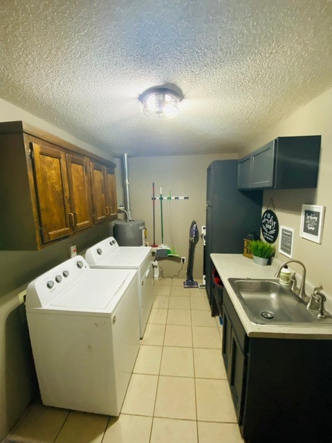 clothes washing area featuring cabinets, a textured ceiling, independent washer and dryer, and sink