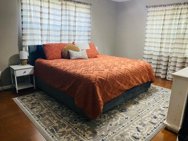 bedroom with dark hardwood / wood-style floors