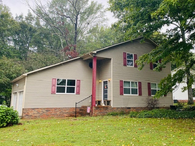 view of front facade with a garage and a front lawn