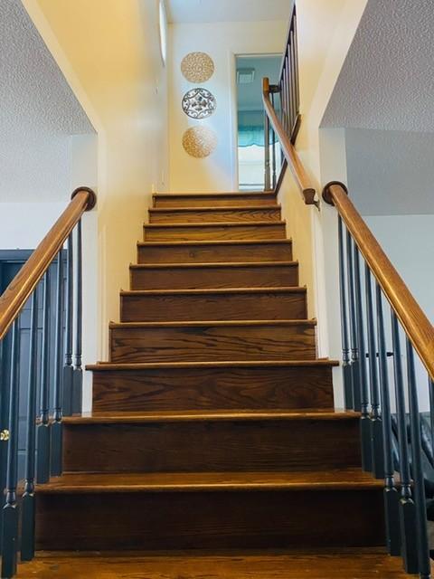 staircase featuring hardwood / wood-style floors