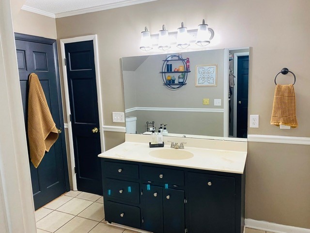 bathroom with vanity, crown molding, and tile patterned floors