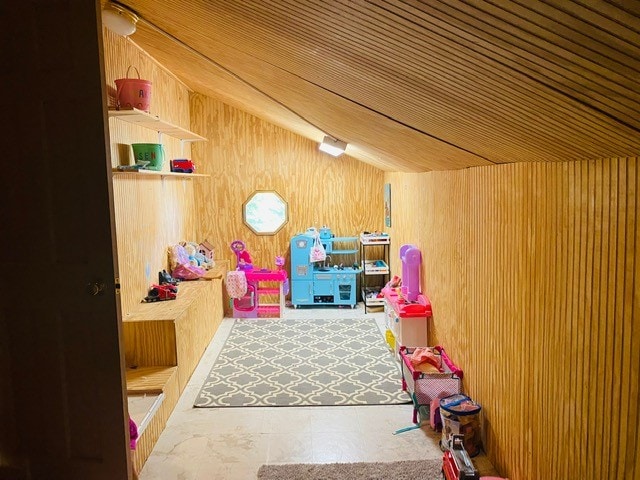 playroom with wooden walls, vaulted ceiling, and wooden ceiling