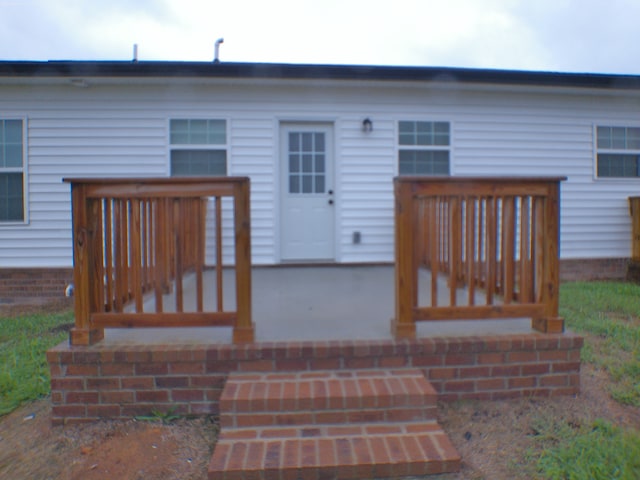 back of property with a deck