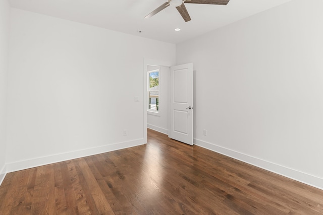 empty room featuring ceiling fan and dark hardwood / wood-style flooring