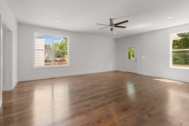 empty room featuring dark wood-type flooring and ceiling fan