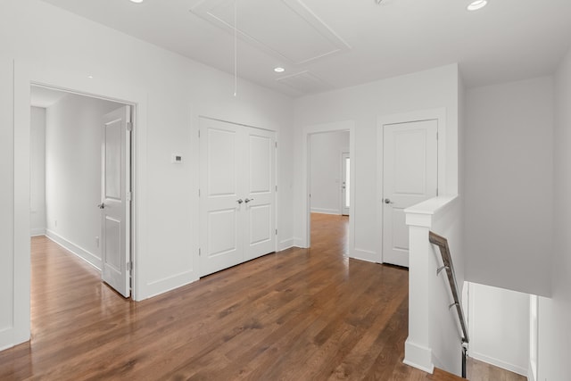 corridor with dark hardwood / wood-style flooring