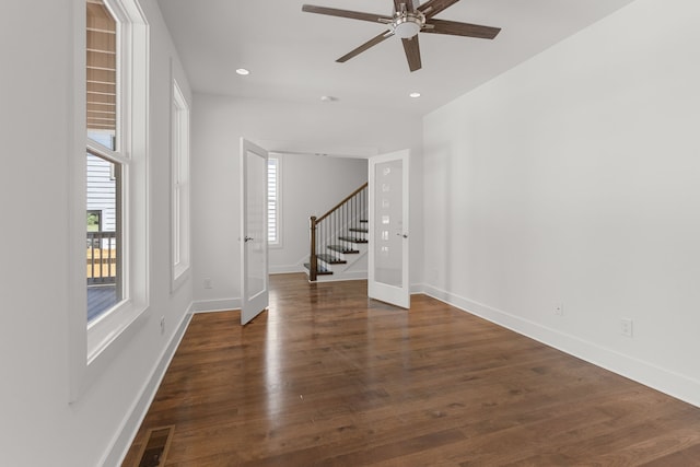 unfurnished room with dark hardwood / wood-style floors and ceiling fan