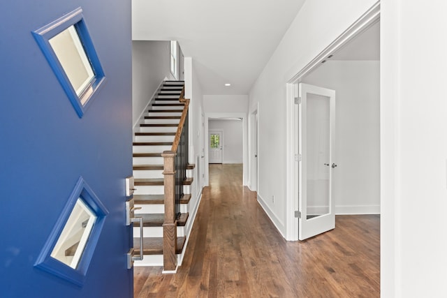 corridor with dark hardwood / wood-style flooring