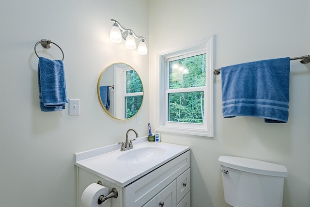 bathroom featuring vanity and toilet