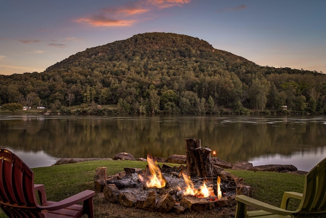 property view of water featuring a mountain view and an outdoor fire pit