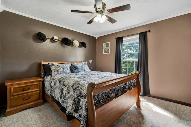 carpeted bedroom featuring ceiling fan and crown molding