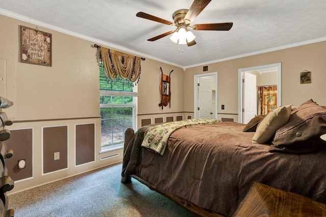 bedroom with a textured ceiling, carpet, ornamental molding, and ceiling fan