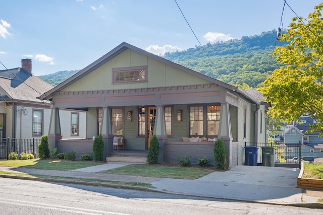 bungalow-style home with covered porch and a mountain view