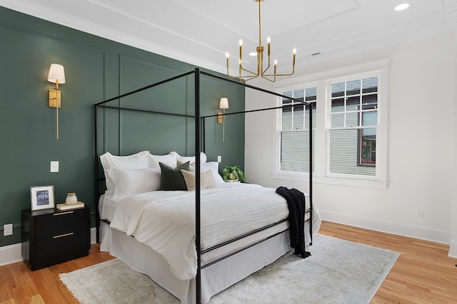 bedroom featuring light wood-type flooring, a chandelier, and ornamental molding