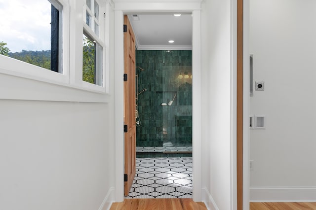 interior space with hardwood / wood-style floors and ornamental molding