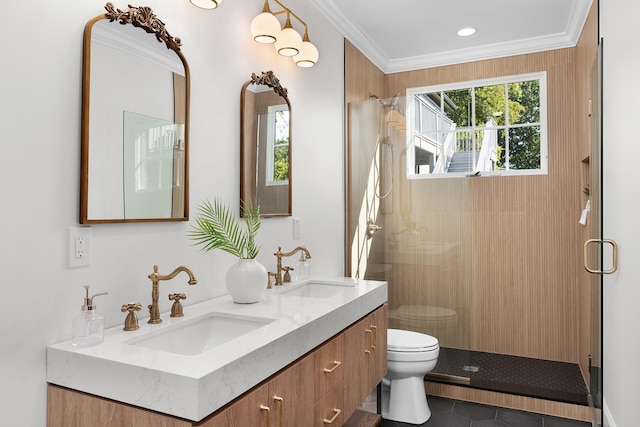 bathroom with toilet, vanity, crown molding, and a shower with shower door