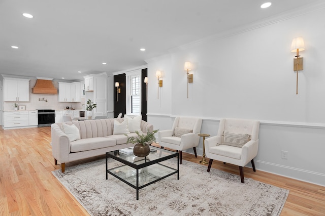 living room featuring ornamental molding and light hardwood / wood-style flooring