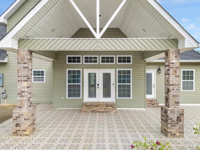 property entrance featuring a patio area and french doors