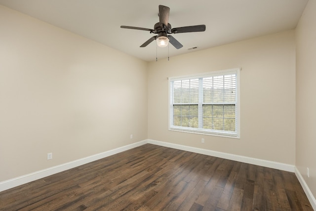 spare room with dark wood-type flooring and ceiling fan