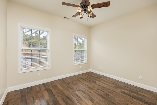 unfurnished room with ceiling fan, a healthy amount of sunlight, and dark hardwood / wood-style floors