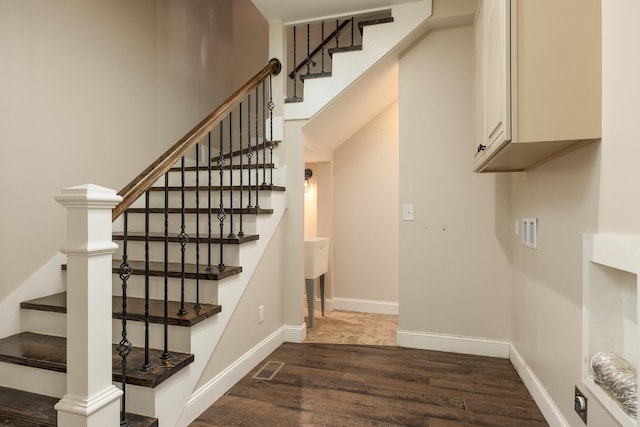 stairway with hardwood / wood-style floors