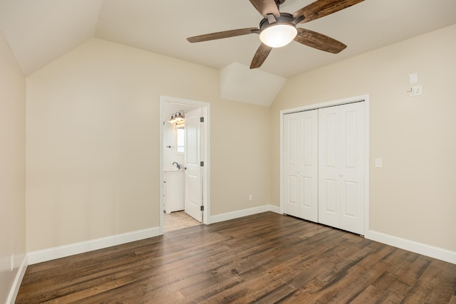 unfurnished bedroom with dark wood-type flooring, ceiling fan, a closet, and lofted ceiling