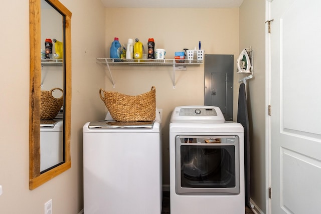 washroom with electric panel and separate washer and dryer