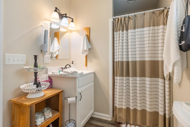 bathroom with vanity, hardwood / wood-style floors, a shower with curtain, and toilet