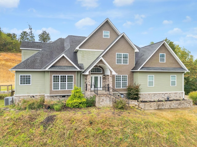 craftsman-style house featuring a front yard and central AC unit