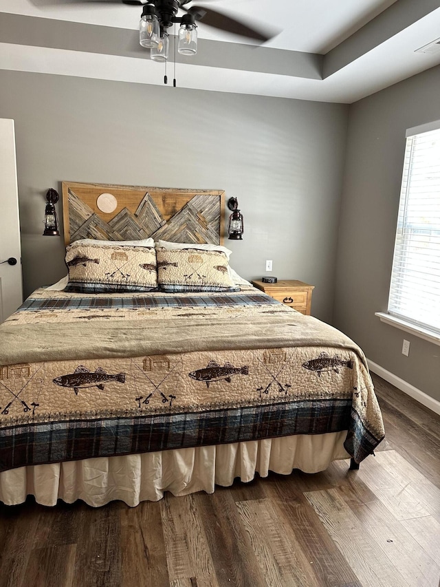 bedroom with ceiling fan and hardwood / wood-style flooring