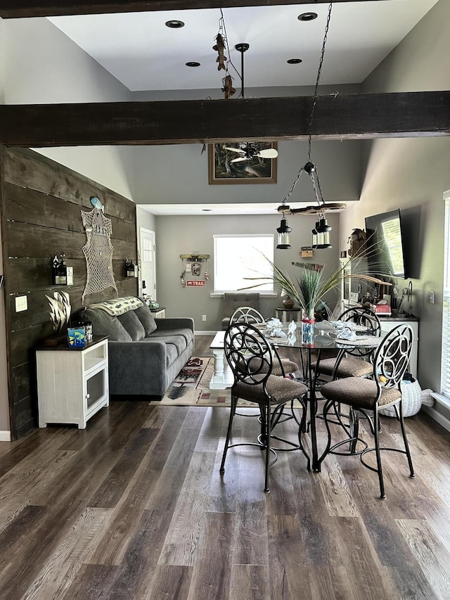 dining area with beam ceiling and wood-type flooring