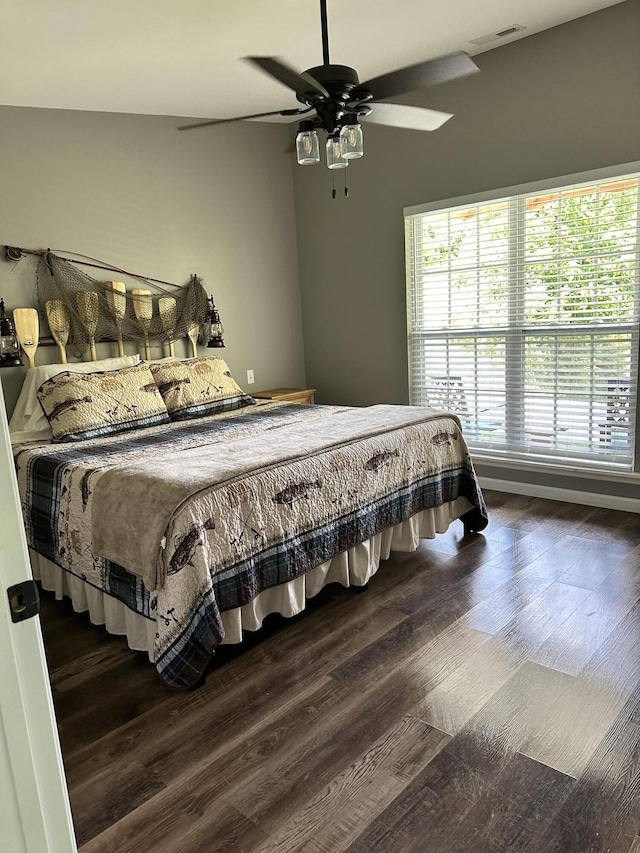 bedroom with ceiling fan and dark hardwood / wood-style floors