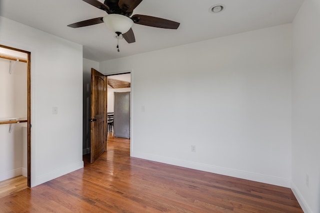 unfurnished bedroom with a closet, ceiling fan, and hardwood / wood-style floors