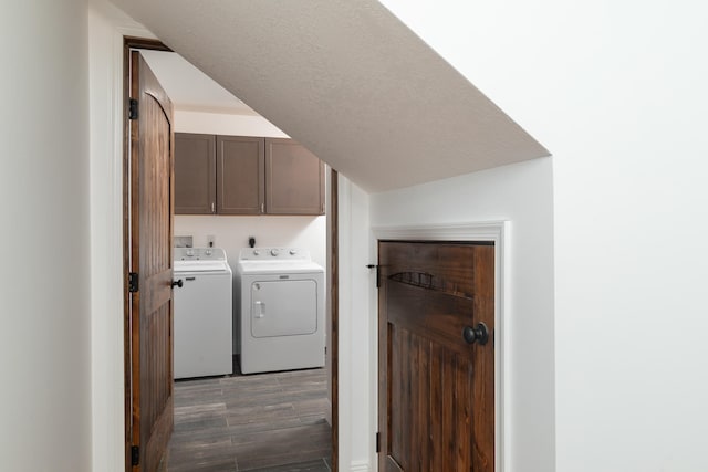 washroom with cabinets, a textured ceiling, washer and dryer, and dark wood-type flooring