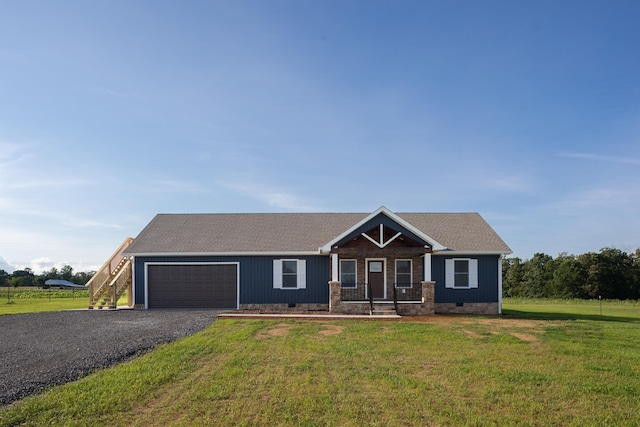 view of front facade with a garage, a porch, and a front lawn