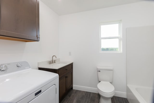 full bathroom featuring vanity, toilet, separate shower and tub, washer / dryer, and hardwood / wood-style floors